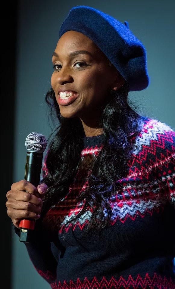 Eraina Ferguson speaking into a microphone on stage
